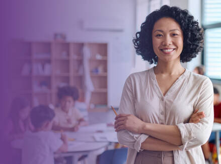 Teacher smiling in front of a classroom